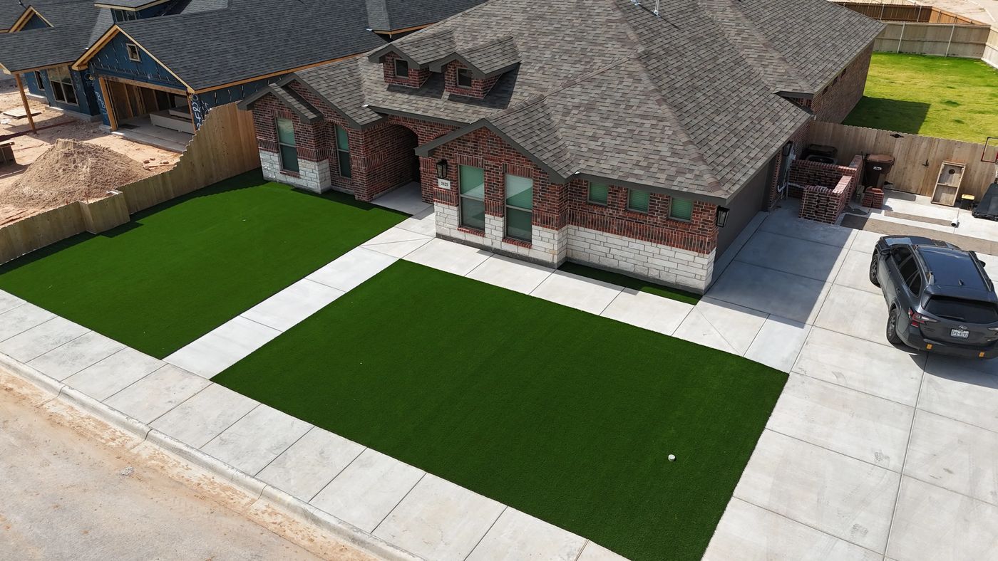 Aerial front-yard artificial turf panels framing a brick home in Deer Meadows, Odessa TX