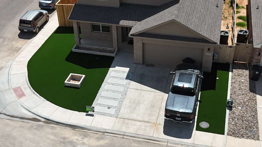 Aerial front-yard artificial turf with large-format paver path and gravel accents in Homestead at Parks Bell Ranch, Odessa TX