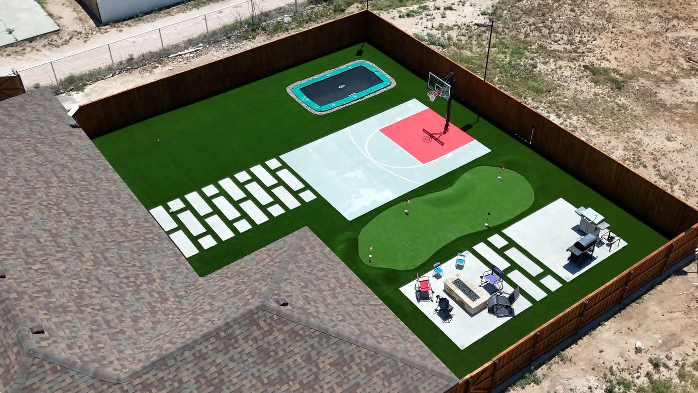Aerial of sport-and-play backyard with court, trampoline, putting green and fire-pit lounge in Legacy South, Midland TX