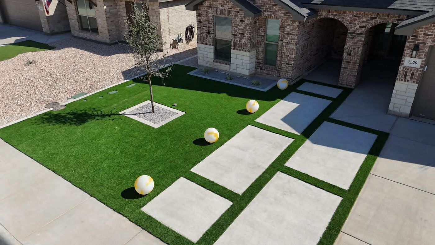 Front-yard artificial turf with large-format paver walkway and xeric gravel beds in Mockingbird Ridge, Midland TX