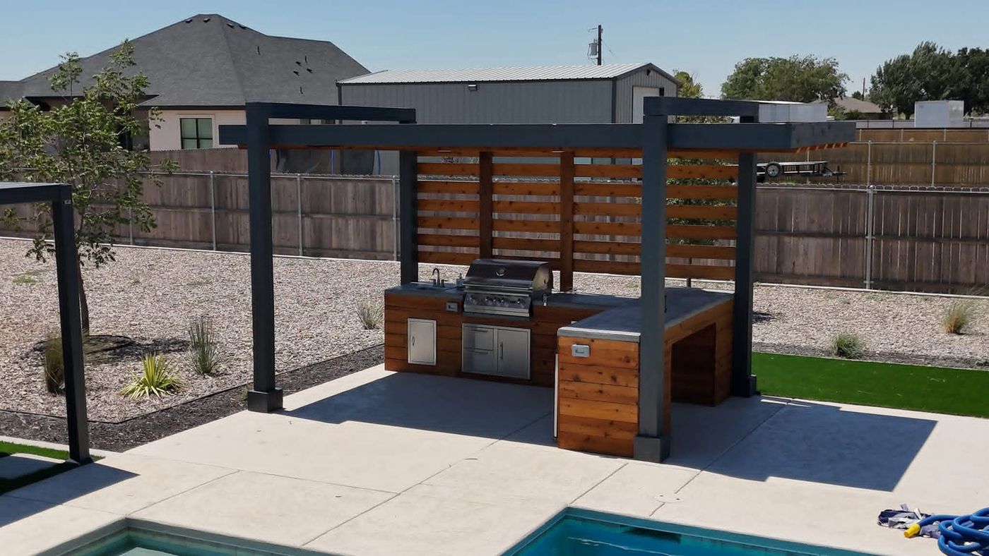 Dark-steel pergola with cedar privacy wall over poolside concrete patio in Mockingbird Ridge, Midland TX