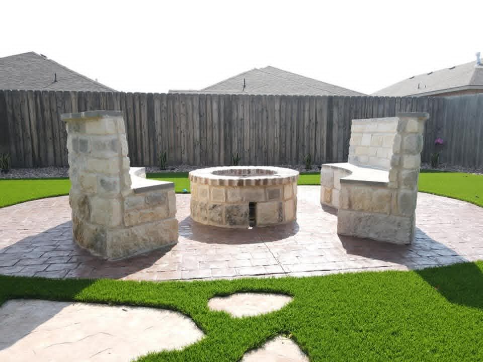 Circular stamped-concrete fire-pit court with stacked-stone fire pit and built-in seat benches in Pecan Grove, Midland TX