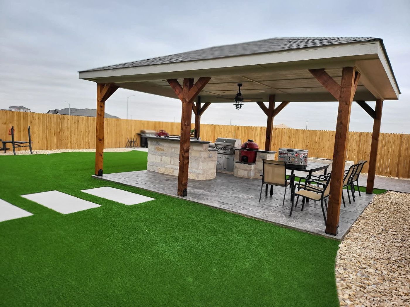 Cedar-post pavilion with full outdoor kitchen, stone-veneer island and built-in grill in Pecan Grove, Midland TX